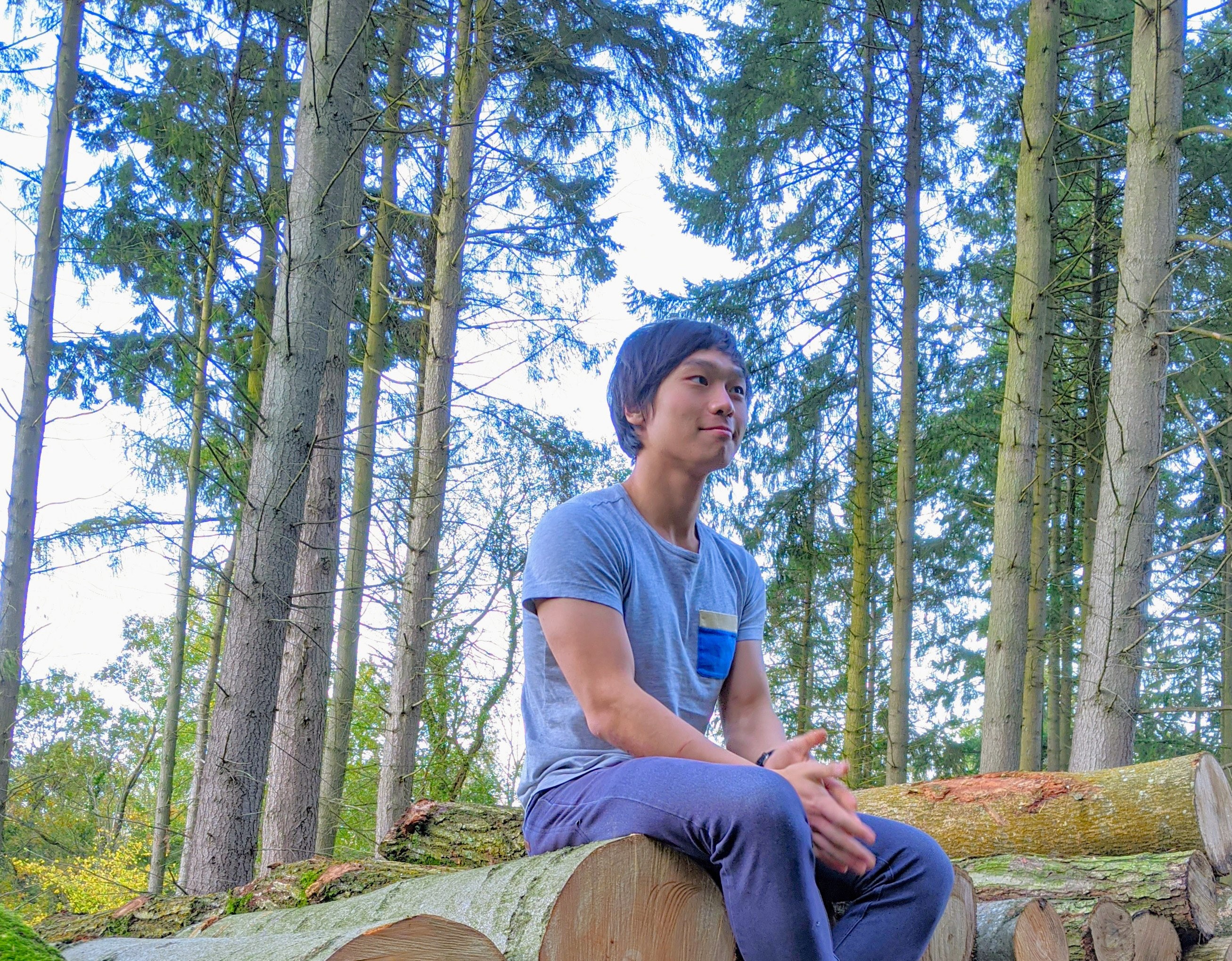 Don't let the picture fool you, I'm not a lumberjack Photo of me sitting in a clearing in the forest